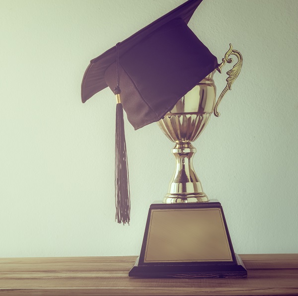 Trophy and graduation cap